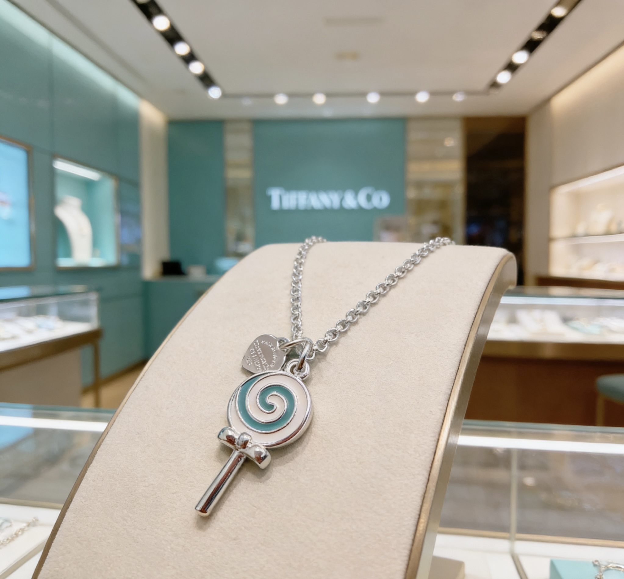 Tiffany Co Lollipop Charm necklace silver-toned metal with Tiffany blue and white enamel accented with clear pave stones on the attached heart tag 18 inches