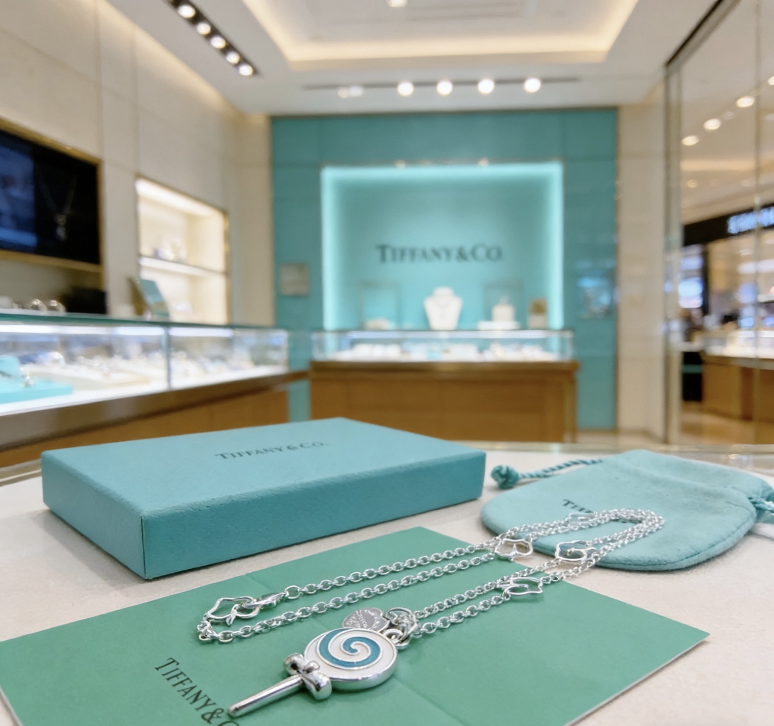 Tiffany Co Lollipop Charm necklace silver-toned metal with Tiffany blue and white enamel accented with clear pave stones on the attached heart tag 18 inches