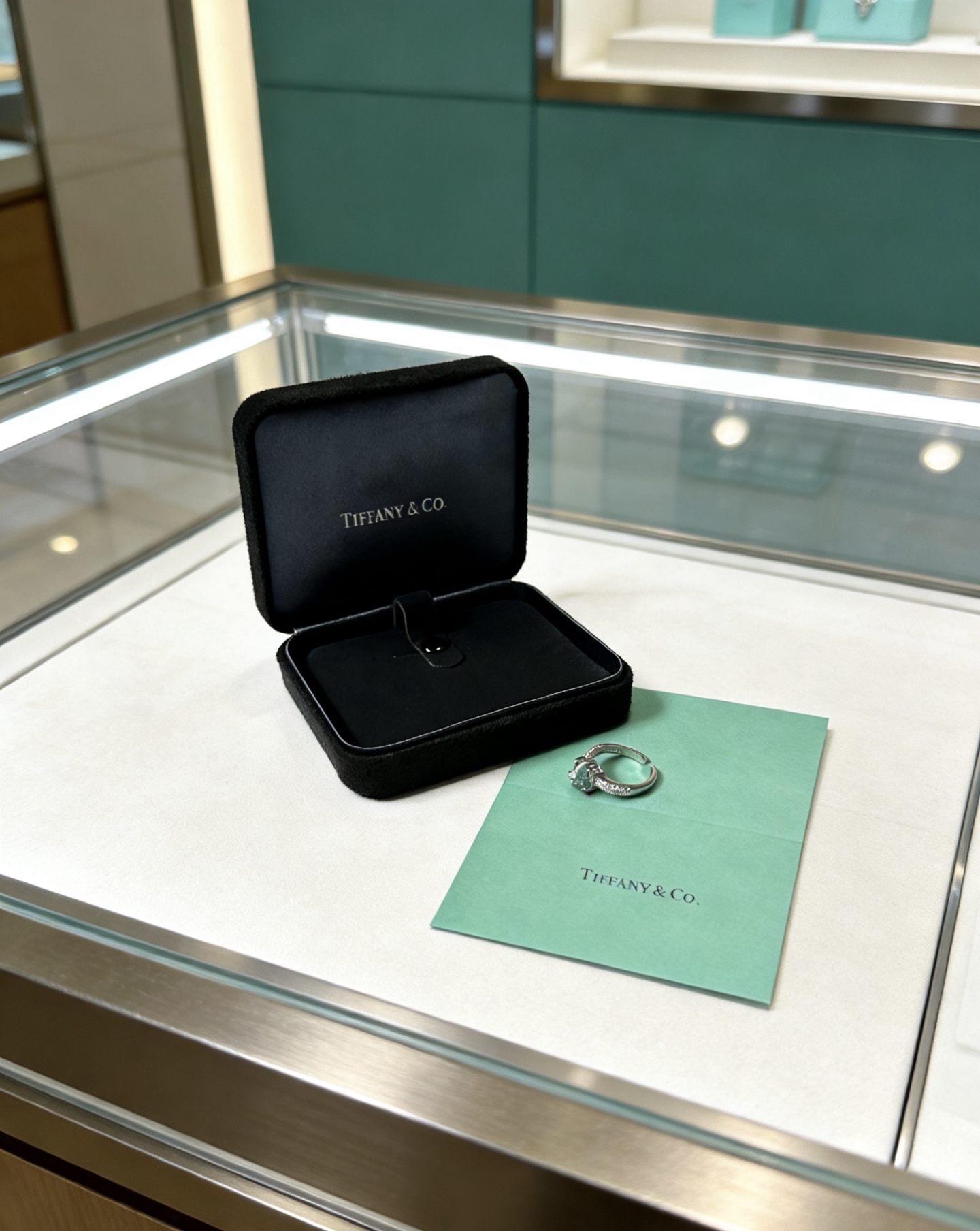 Tiffany Co ring silver-toned white metal with green gemstone and clear diamond accents adjustable open band