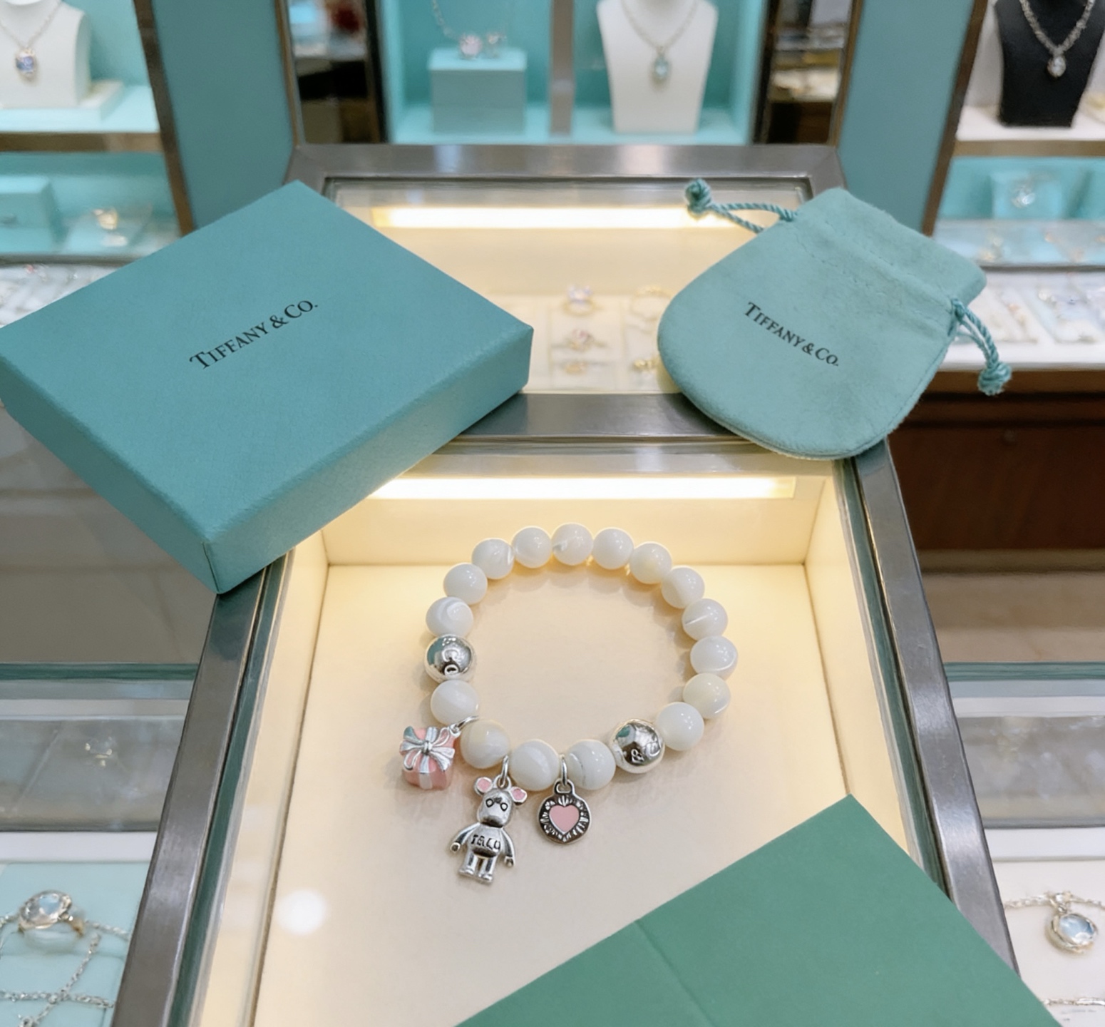 Tiffany Co Charm Bead Bracelet bracelet Silver-toned metal with white mother-of-pearl beads pink enamel accents on charms 17cm