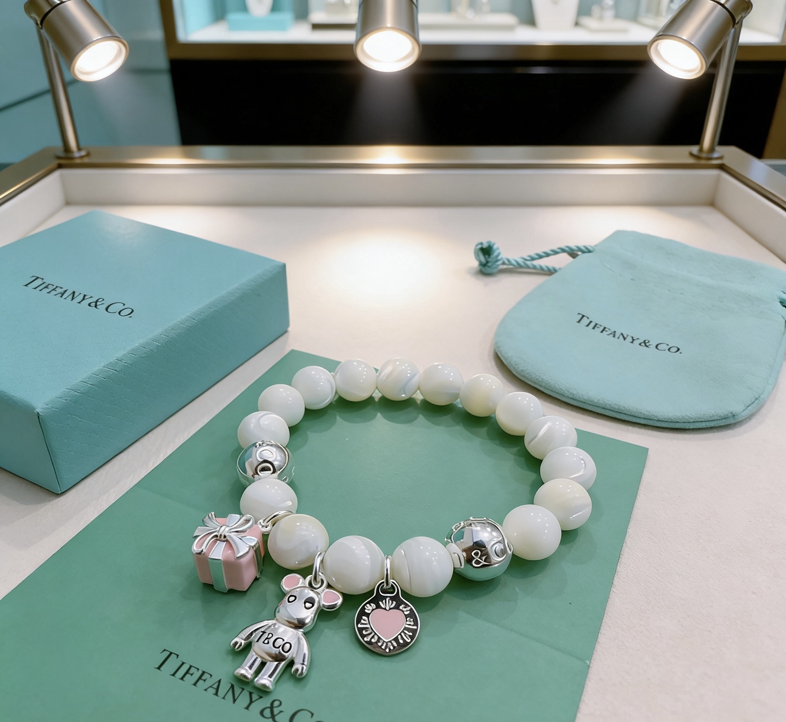 Tiffany Co Charm Bead Bracelet bracelet Silver-toned metal with white mother-of-pearl beads pink enamel accents on charms 17cm