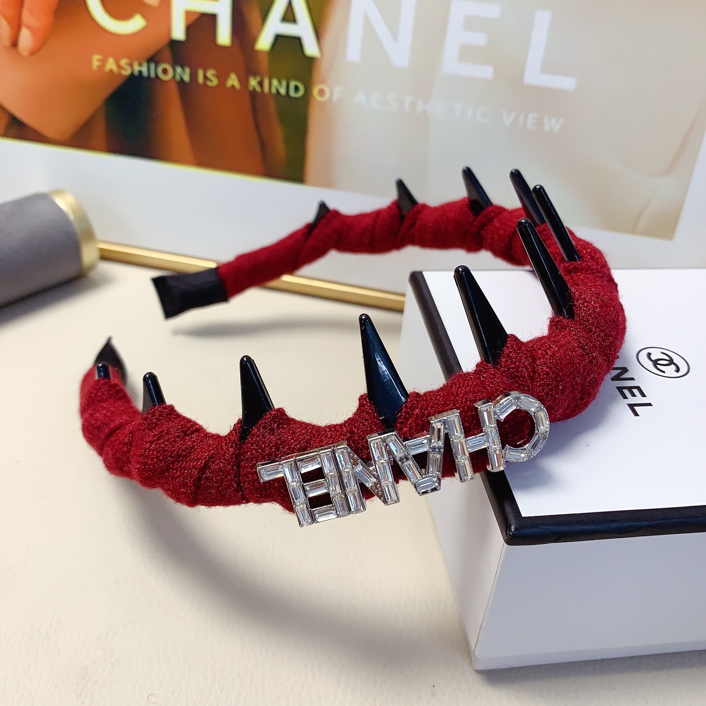 Chanel Crystal Logo Spiked Headband brooch Red fabric with black spikes and silver-tone crystal logo Black and white tweed fabric with black spikes and gold-tone CD logo One Size