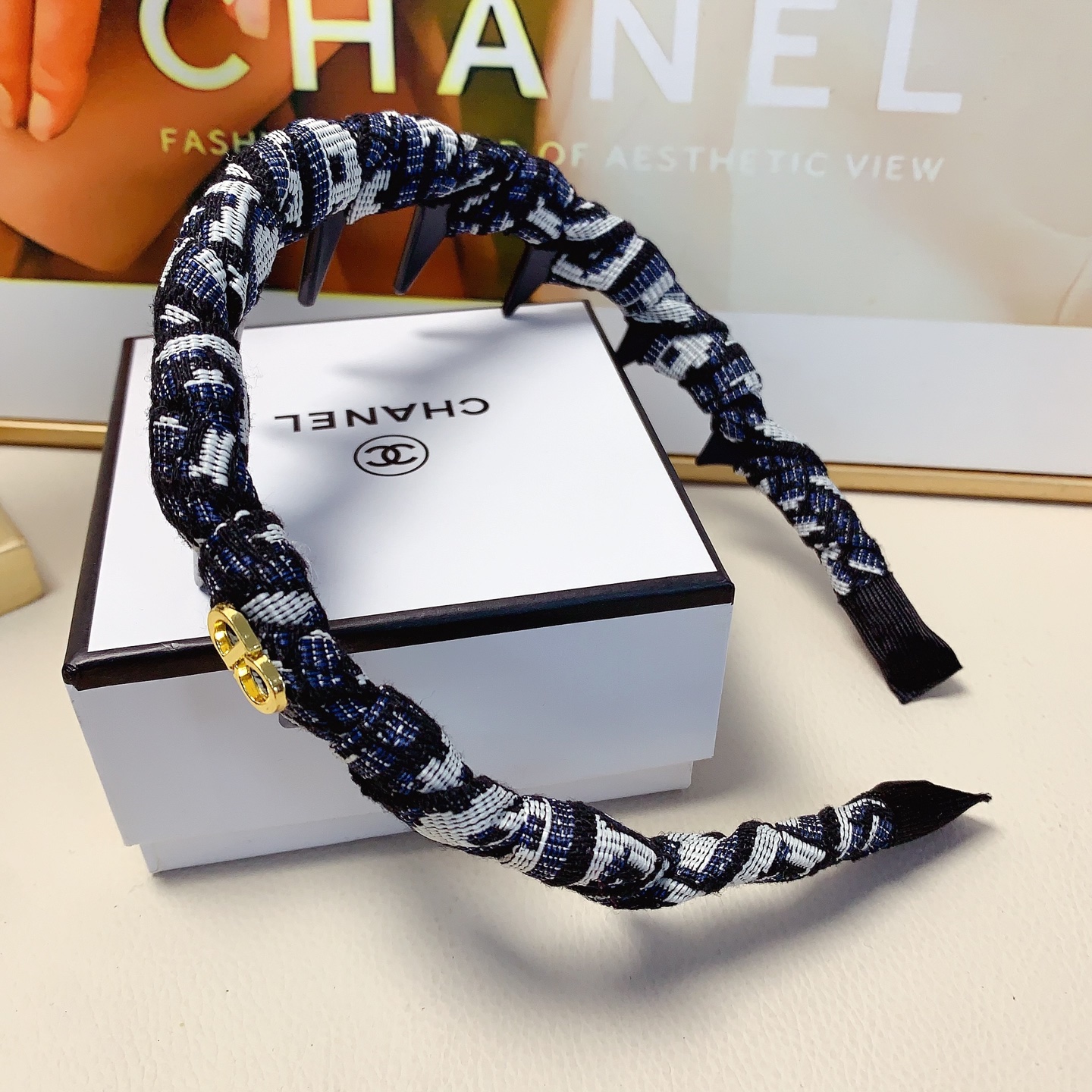 Chanel Crystal Logo Spiked Headband brooch Red fabric with black spikes and silver-tone crystal logo Black and white tweed fabric with black spikes and gold-tone CD logo One Size