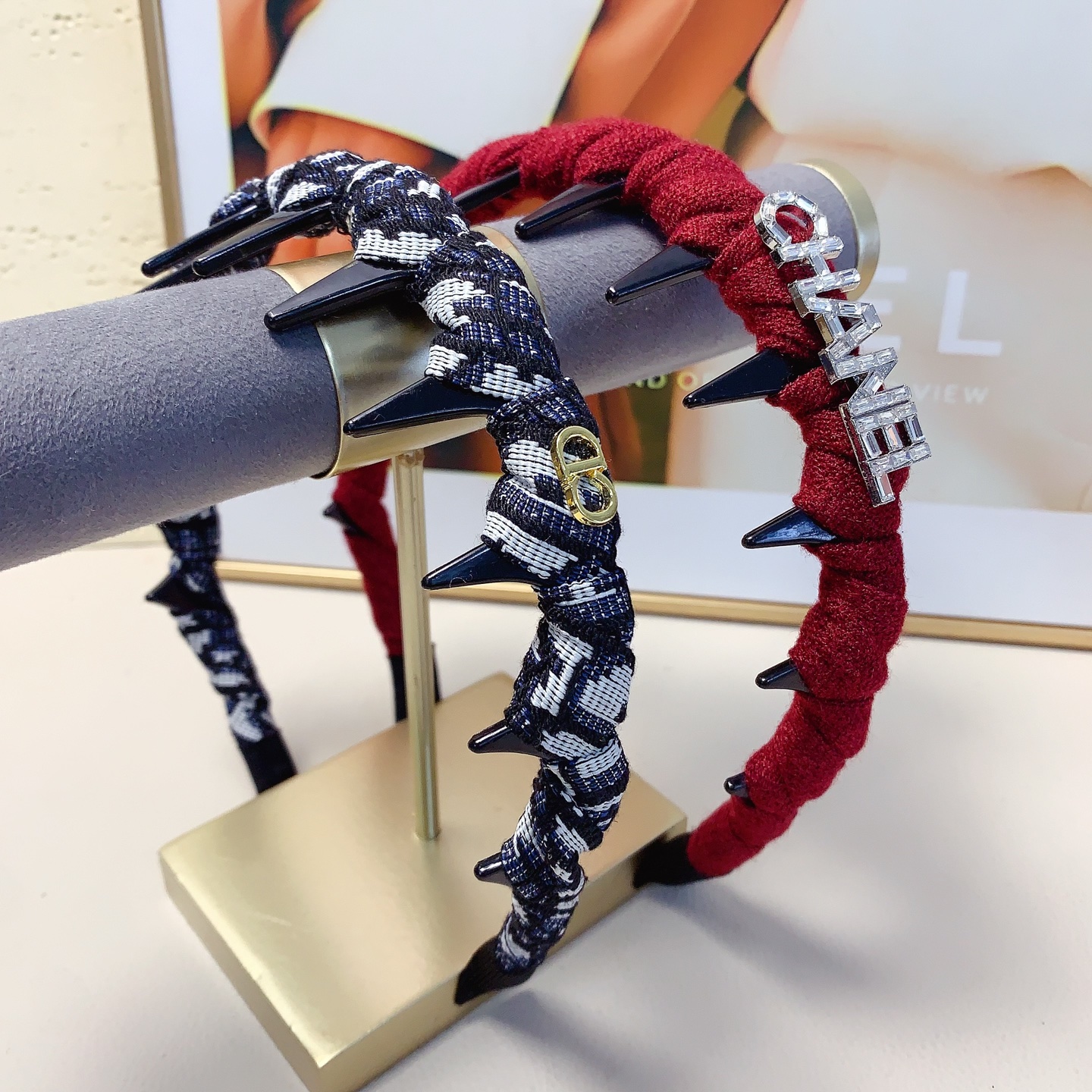 Chanel Crystal Logo Spiked Headband brooch Red fabric with black spikes and silver-tone crystal logo Black and white tweed fabric with black spikes and gold-tone CD logo One Size