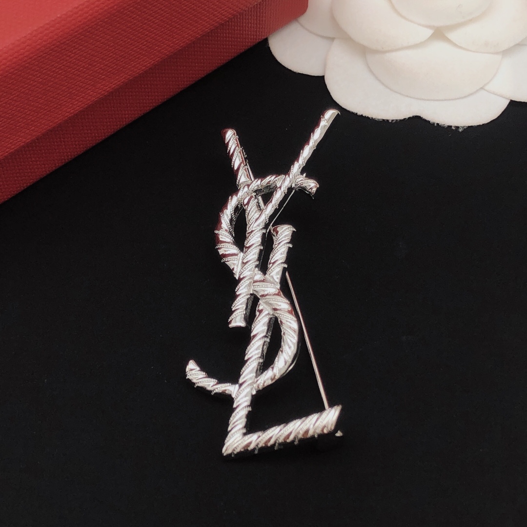 Saint Laurent Cassandre Twisted Monogram brooch silver tone metal no gemstones 4 5cm height
