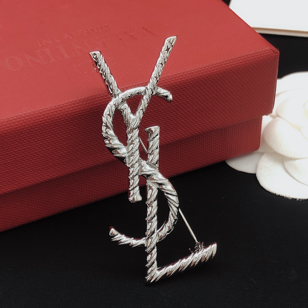 Saint Laurent Cassandre Twisted Monogram brooch silver tone metal no gemstones 4 5cm height