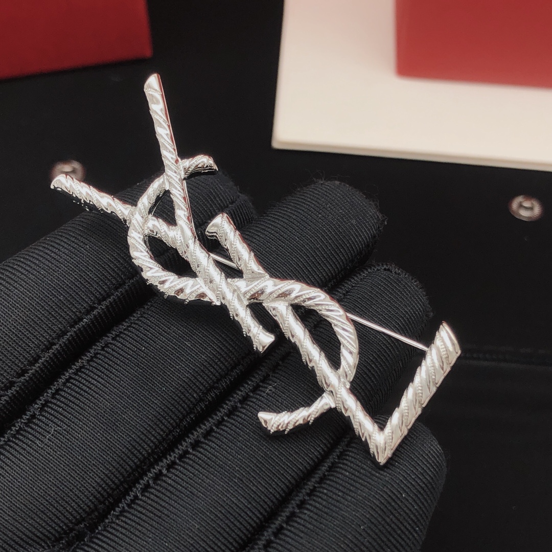 Saint Laurent Cassandre Twisted Monogram brooch silver tone metal no gemstones 4 5cm height