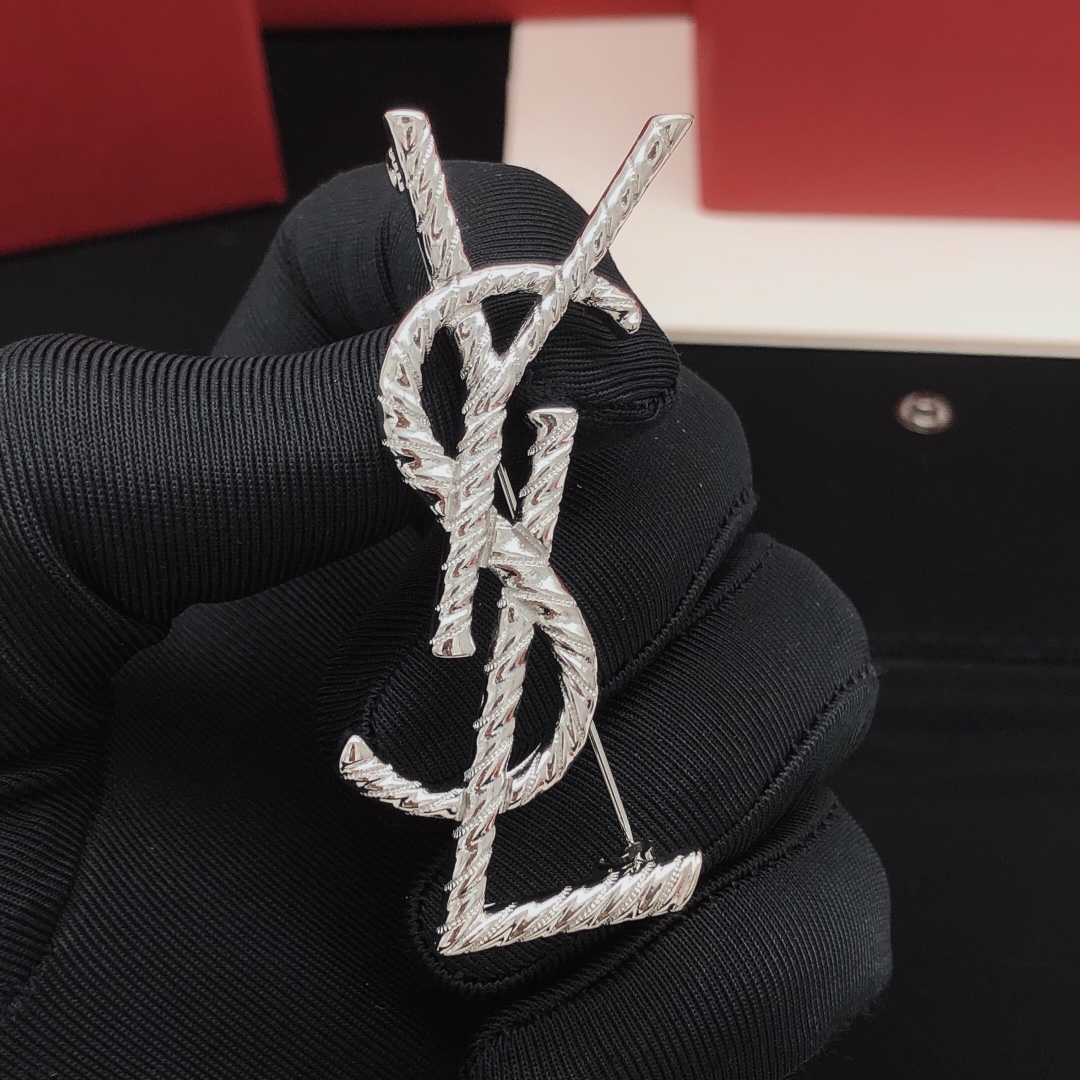 Saint Laurent Cassandre Twisted Monogram brooch silver tone metal no gemstones 4 5cm height