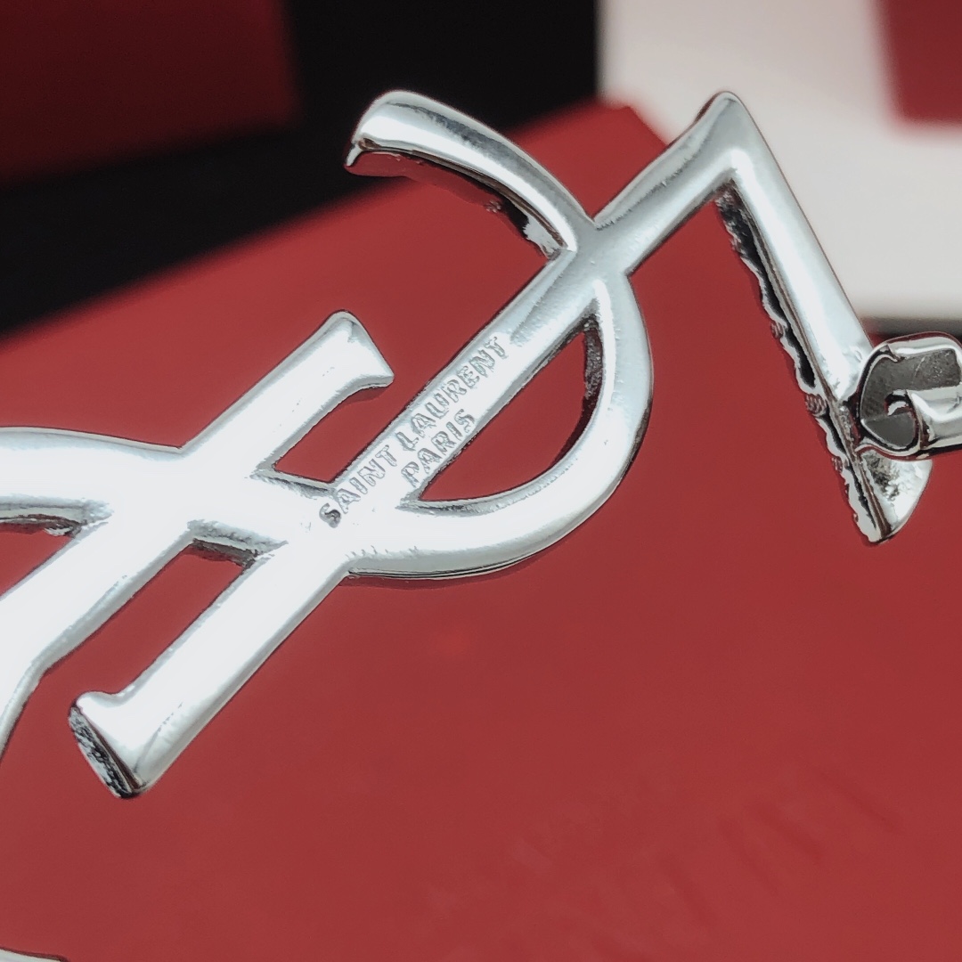 Saint Laurent Cassandre Twisted Monogram brooch silver tone metal no gemstones 4 5cm height