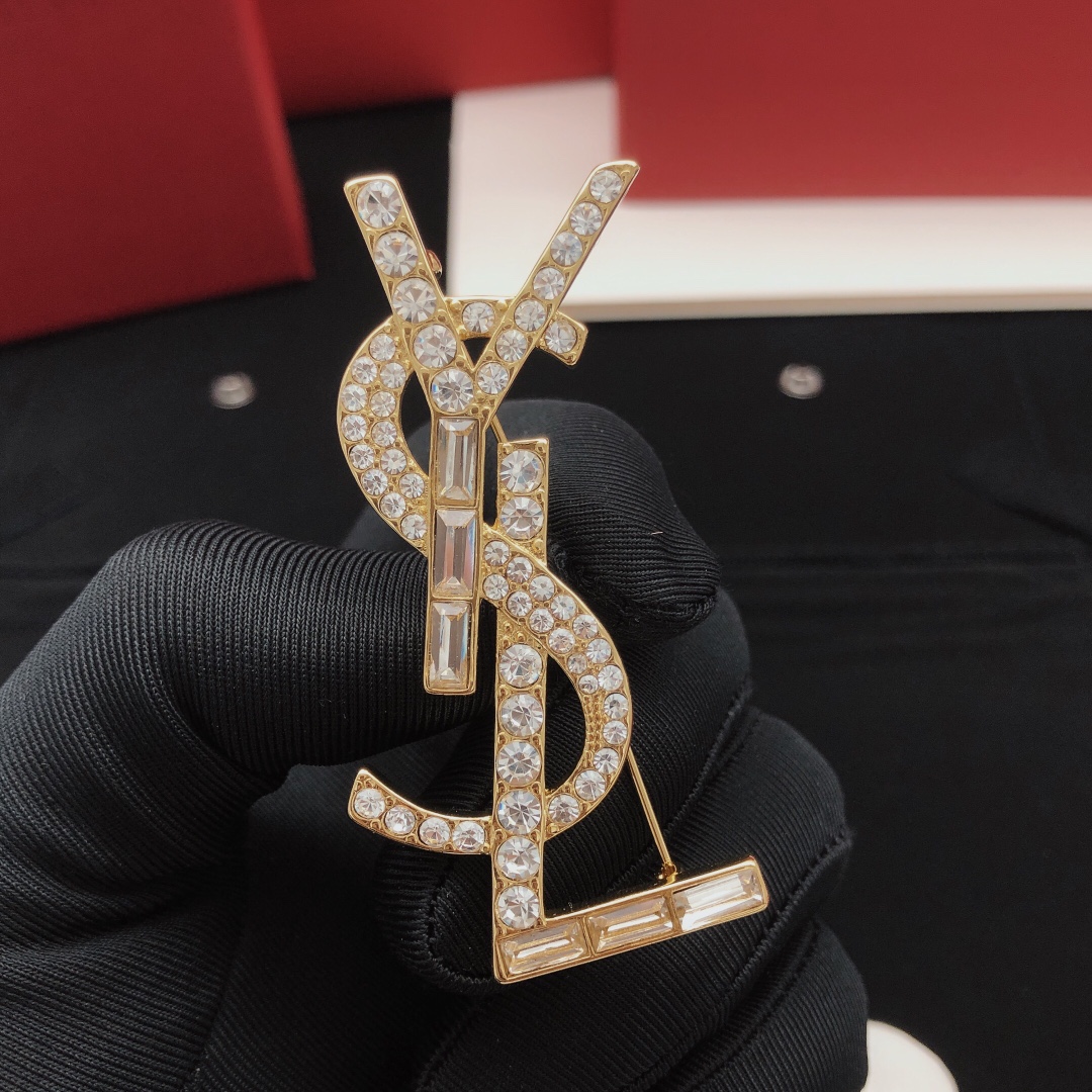 Saint Laurent Cassandre YSL Monogram brooch gold-tone metal with clear round and baguette-cut crystals 4 5cm