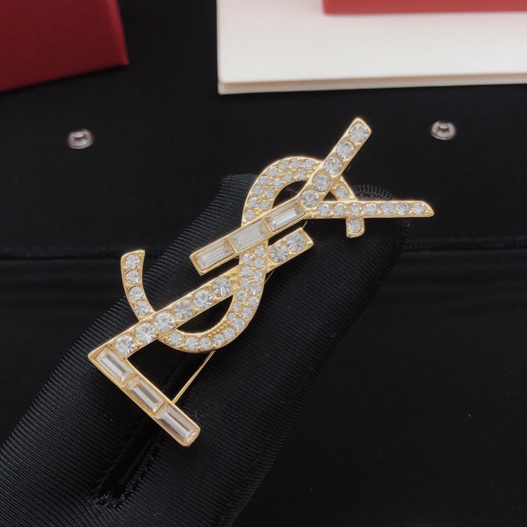 Saint Laurent Cassandre YSL Monogram brooch gold-tone metal with clear round and baguette-cut crystals 4 5cm