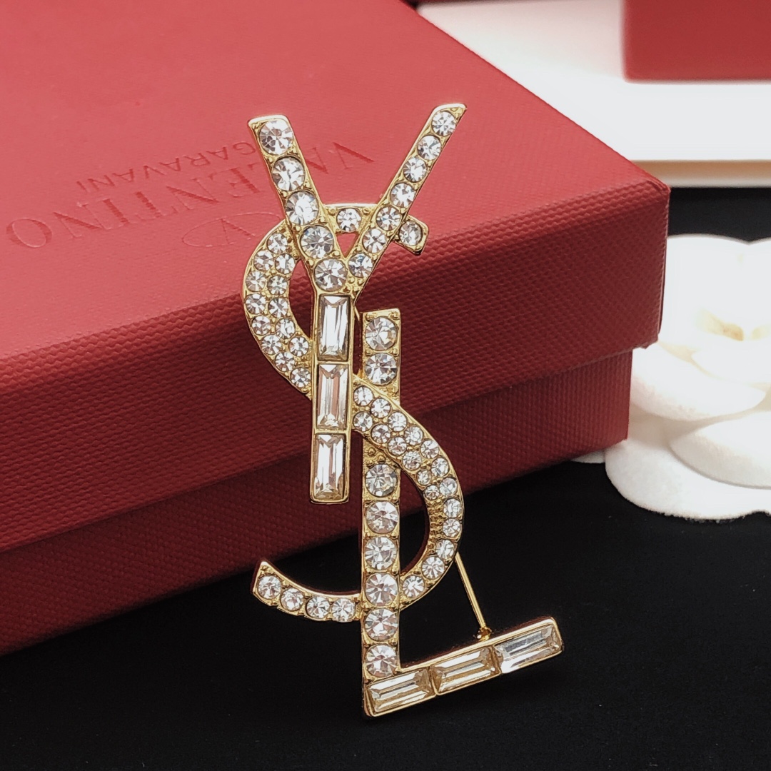 Saint Laurent Cassandre YSL Monogram brooch gold-tone metal with clear round and baguette-cut crystals 4 5cm