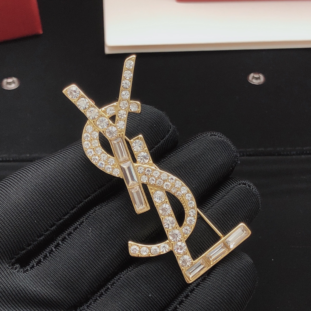 Saint Laurent Cassandre YSL Monogram brooch gold-tone metal with clear round and baguette-cut crystals 4 5cm