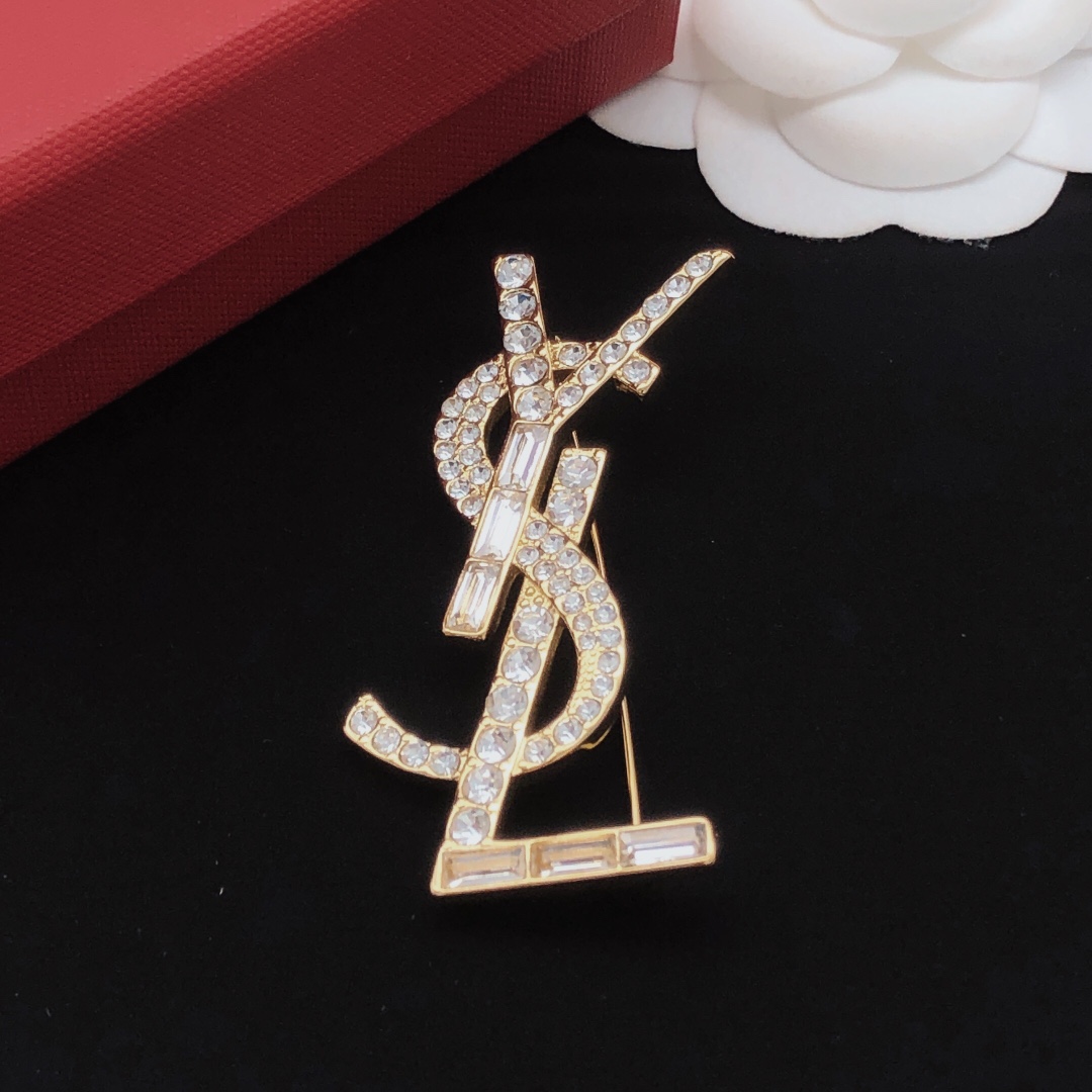 Saint Laurent Cassandre YSL Monogram brooch gold-tone metal with clear round and baguette-cut crystals 4 5cm