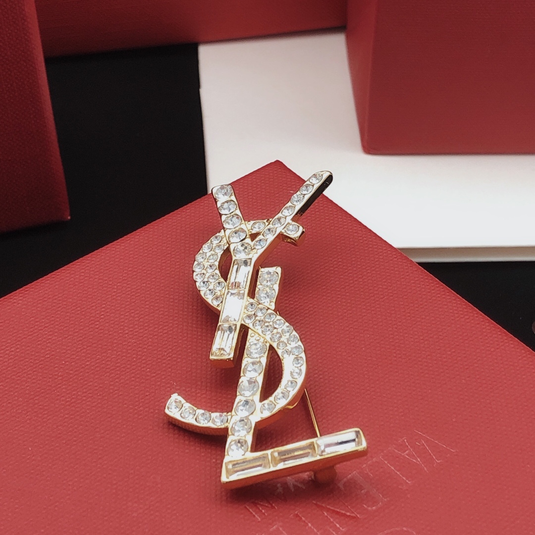Saint Laurent Cassandre YSL Monogram brooch gold-tone metal with clear round and baguette-cut crystals 4 5cm