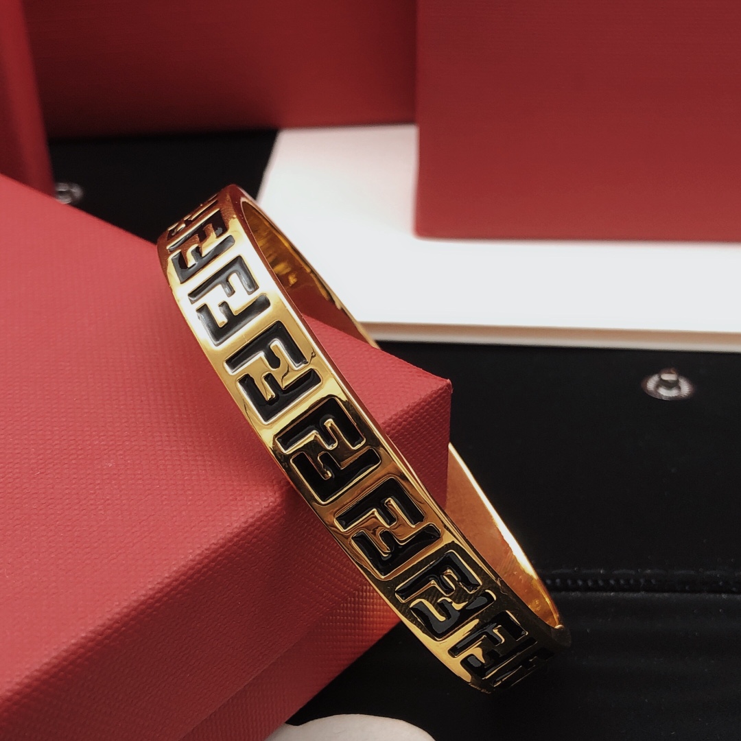 Fendi FF Logo Bangle bracelet gold-tone metal with black enamel FF monogram detailing 17cm inner circumference