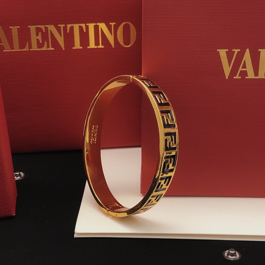 Fendi FF Logo Bangle bracelet gold-tone metal with black enamel FF monogram detailing 17cm inner circumference