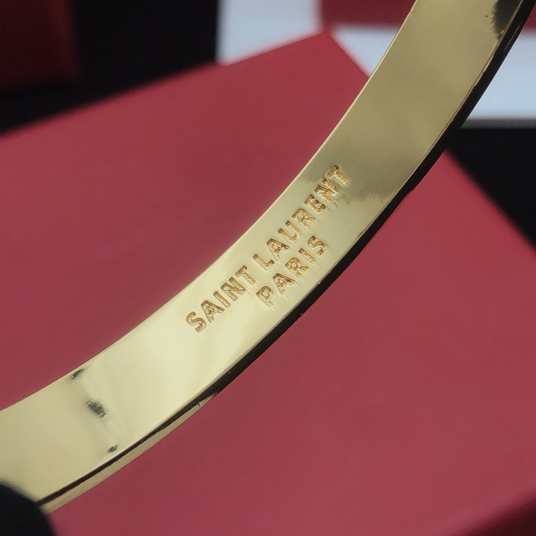 Saint Laurent Cassandre Monogram Pave Bangle bracelet gold-tone metal with clear pave crystals 17cm inner circumference