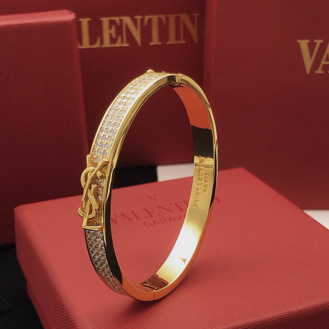 Saint Laurent Cassandre Monogram Pave Bangle bracelet gold-tone metal with clear pave crystals 17cm inner circumference