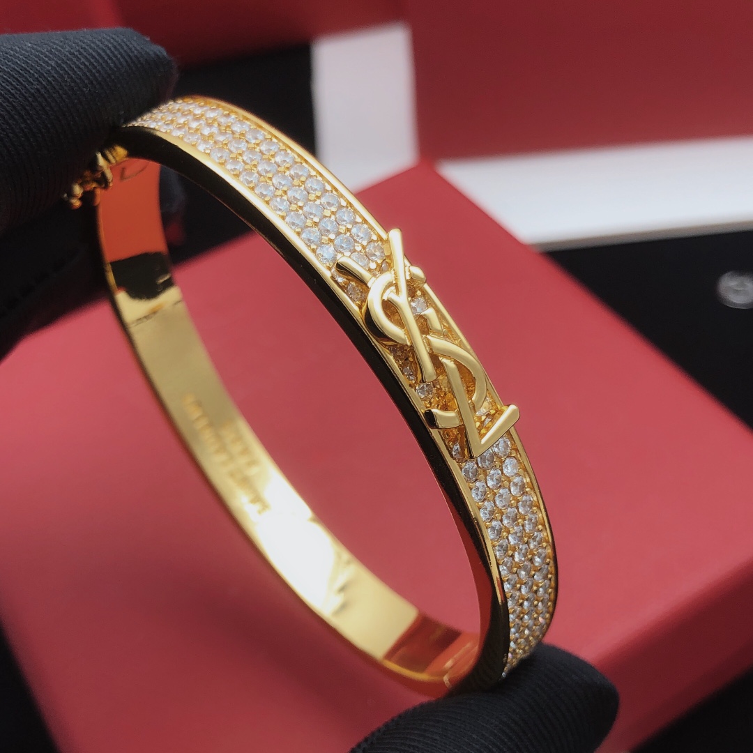 Saint Laurent Cassandre Monogram Pave Bangle bracelet gold-tone metal with clear pave crystals 17cm inner circumference