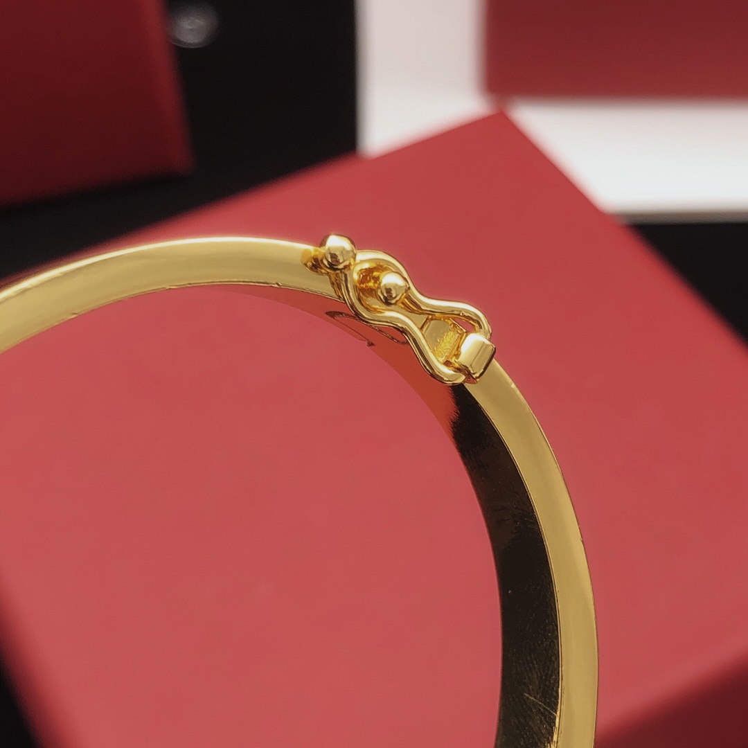 Saint Laurent Cassandre Monogram Pave Bangle bracelet gold-tone metal with clear pave crystals 17cm inner circumference