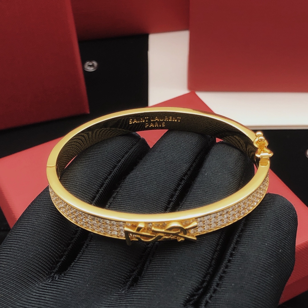 Saint Laurent Cassandre Monogram Pave Bangle bracelet gold-tone metal with clear pave crystals 17cm inner circumference