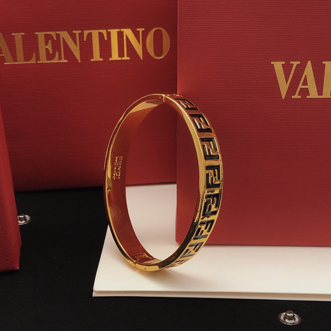 Fendi FF Logo Bangle bracelet gold-tone metal with black enamel FF detailing 17cm inner circumference