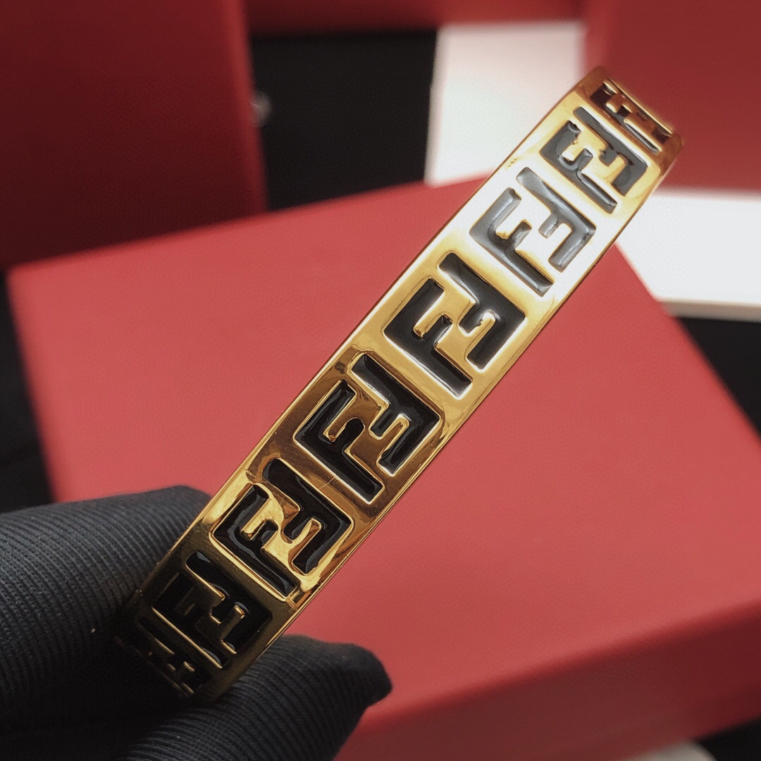 Fendi FF Logo Bangle bracelet gold-tone metal with black enamel FF detailing 17cm inner circumference