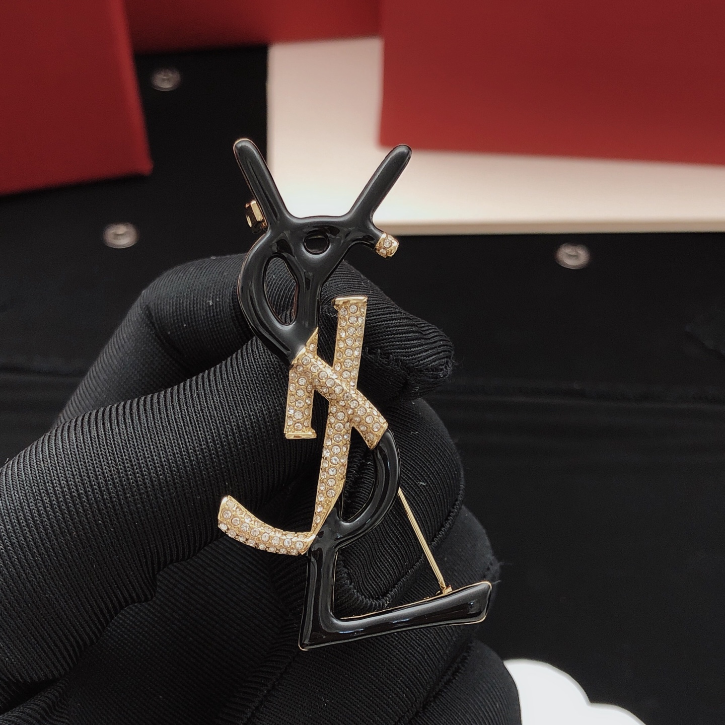 Saint Laurent Cassandre Monogram Brooch brooch gold-tone metal with clear pave crystals available in black enamel and white enamel variants 4 5cm height