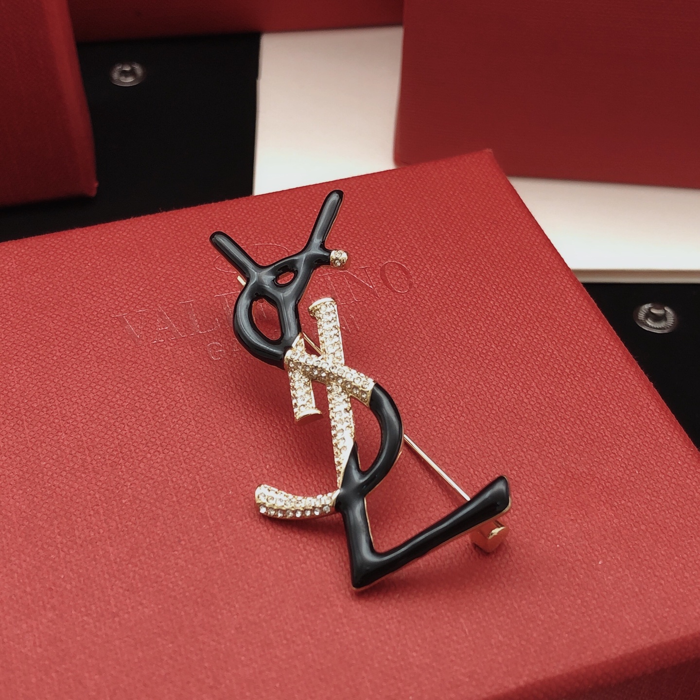 Saint Laurent Cassandre Monogram Brooch brooch gold-tone metal with clear pave crystals available in black enamel and white enamel variants 4 5cm height