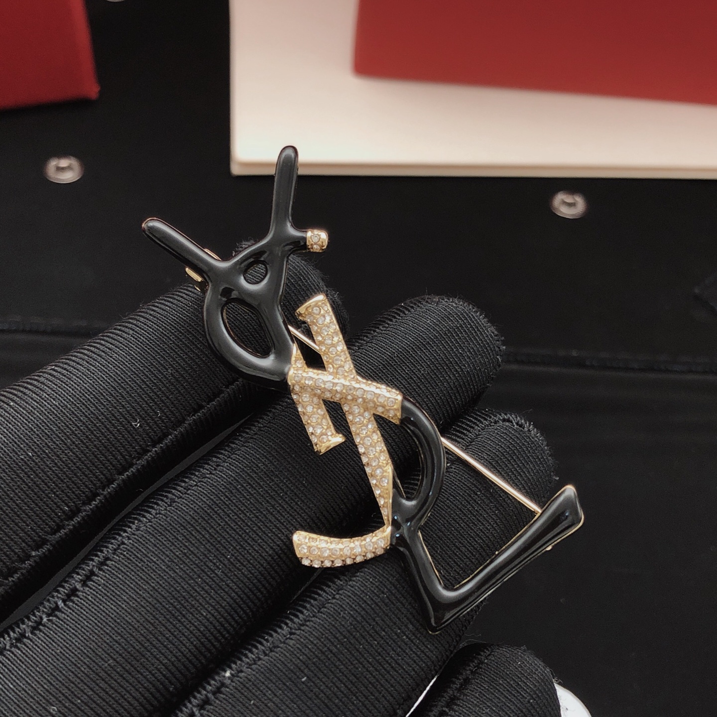 Saint Laurent Cassandre Monogram Brooch brooch gold-tone metal with clear pave crystals available in black enamel and white enamel variants 4 5cm height