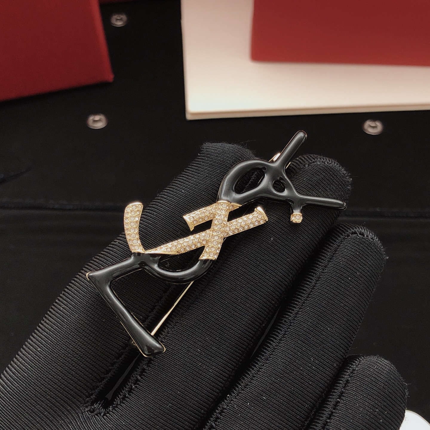 Saint Laurent Cassandre Monogram Brooch brooch gold-tone metal with clear pave crystals available in black enamel and white enamel variants 4 5cm height