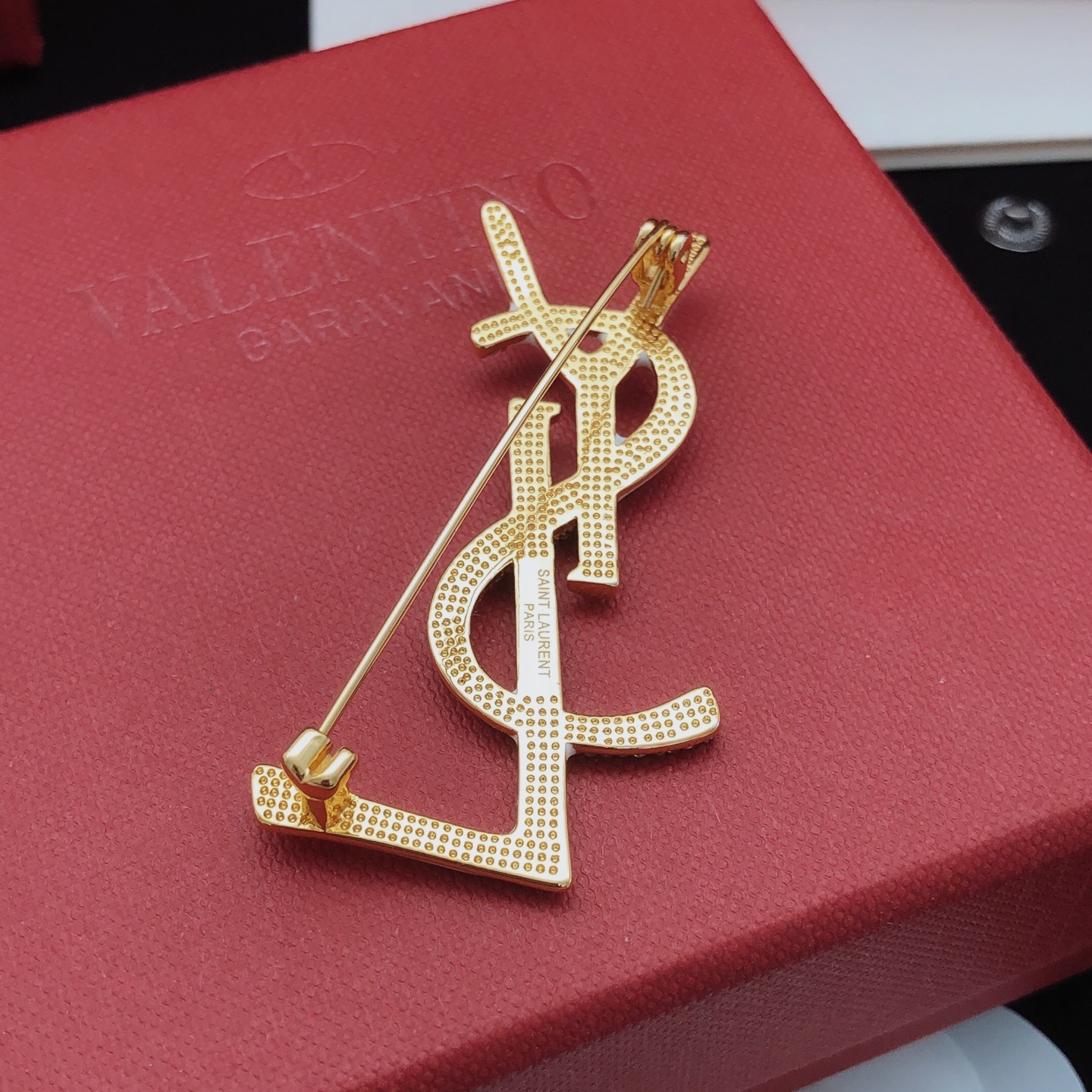 Saint Laurent Cassandre Monogram Brooch brooch gold-tone metal with clear pave crystals available in black enamel and white enamel variants 4 5cm height