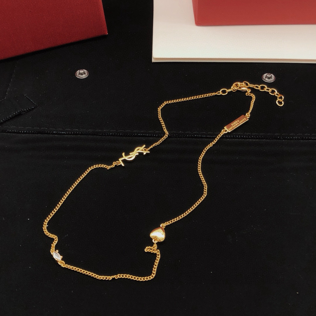 Saint Laurent YSL Monogram Heart Crystal Chain necklace gold-tone metal with clear faceted crystal and polished gold heart charm 42cm with 5cm extender