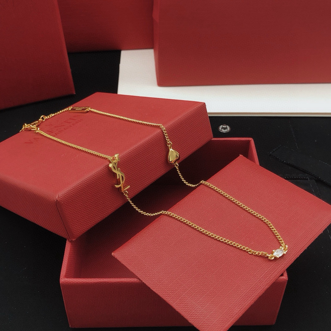 Saint Laurent YSL Monogram Heart Crystal Chain necklace gold-tone metal with clear faceted crystal and polished gold heart charm 42cm with 5cm extender