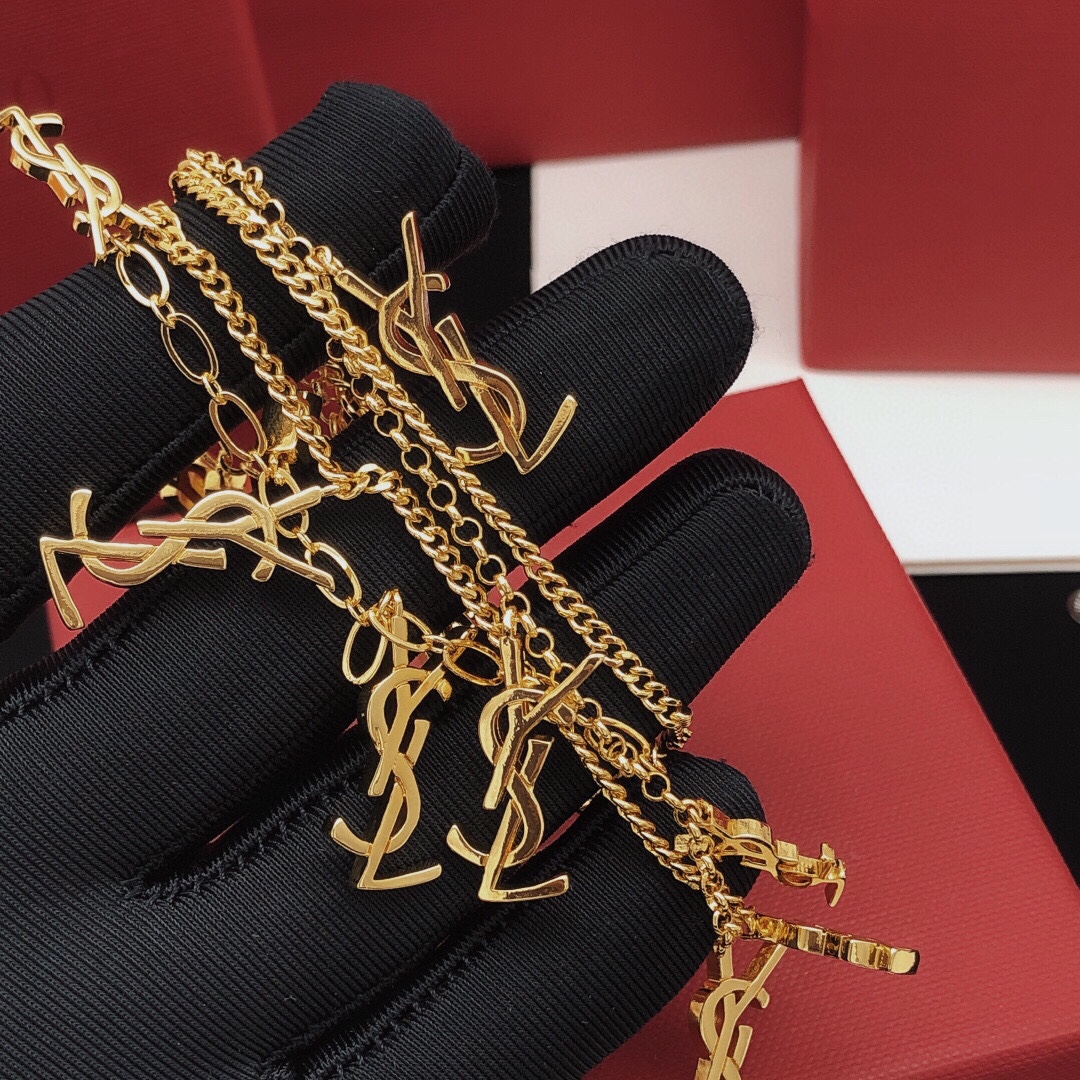 Saint Laurent Cassandre Multi-Charm Toggle Bracelet bracelet gold-tone metal with clear baguette-cut crystal accents 19cm