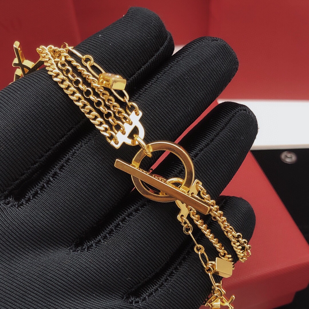 Saint Laurent Cassandre Multi-Charm Toggle Bracelet bracelet gold-tone metal with clear baguette-cut crystal accents 19cm