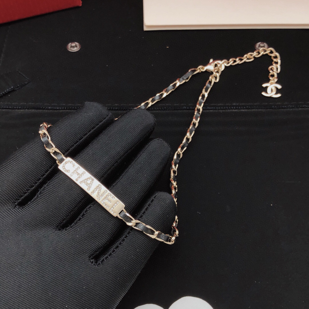 Chanel Leather Woven Chain Crystal Logo Plate Choker necklace Gold-tone metal black leather clear crystal 40cm with 5cm extender