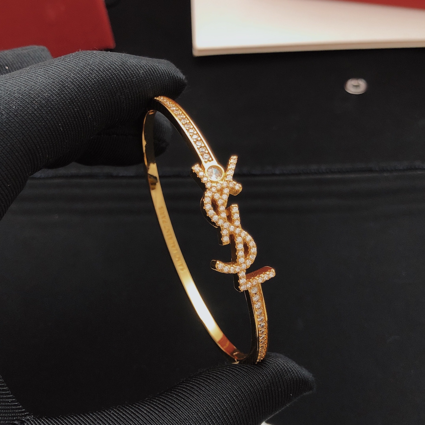 Saint Laurent Cassandre YSL Monogram Crystal Bangle bracelet gold-tone metal with clear crystal accents 17cm inner circumference