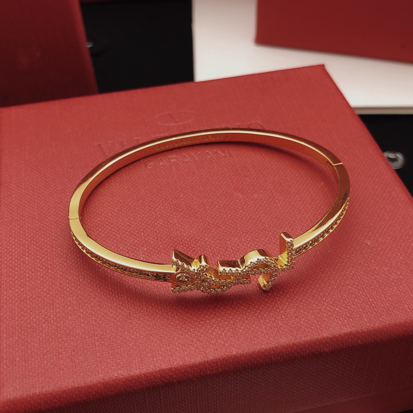 Saint Laurent Cassandre YSL Monogram Crystal Bangle bracelet gold-tone metal with clear crystal accents 17cm inner circumference
