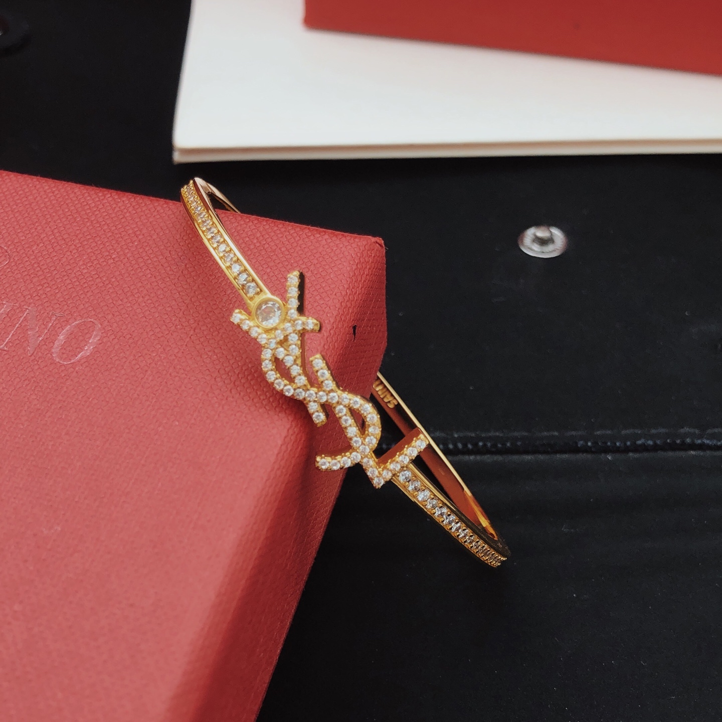 Saint Laurent Cassandre YSL Monogram Crystal Bangle bracelet gold-tone metal with clear crystal accents 17cm inner circumference