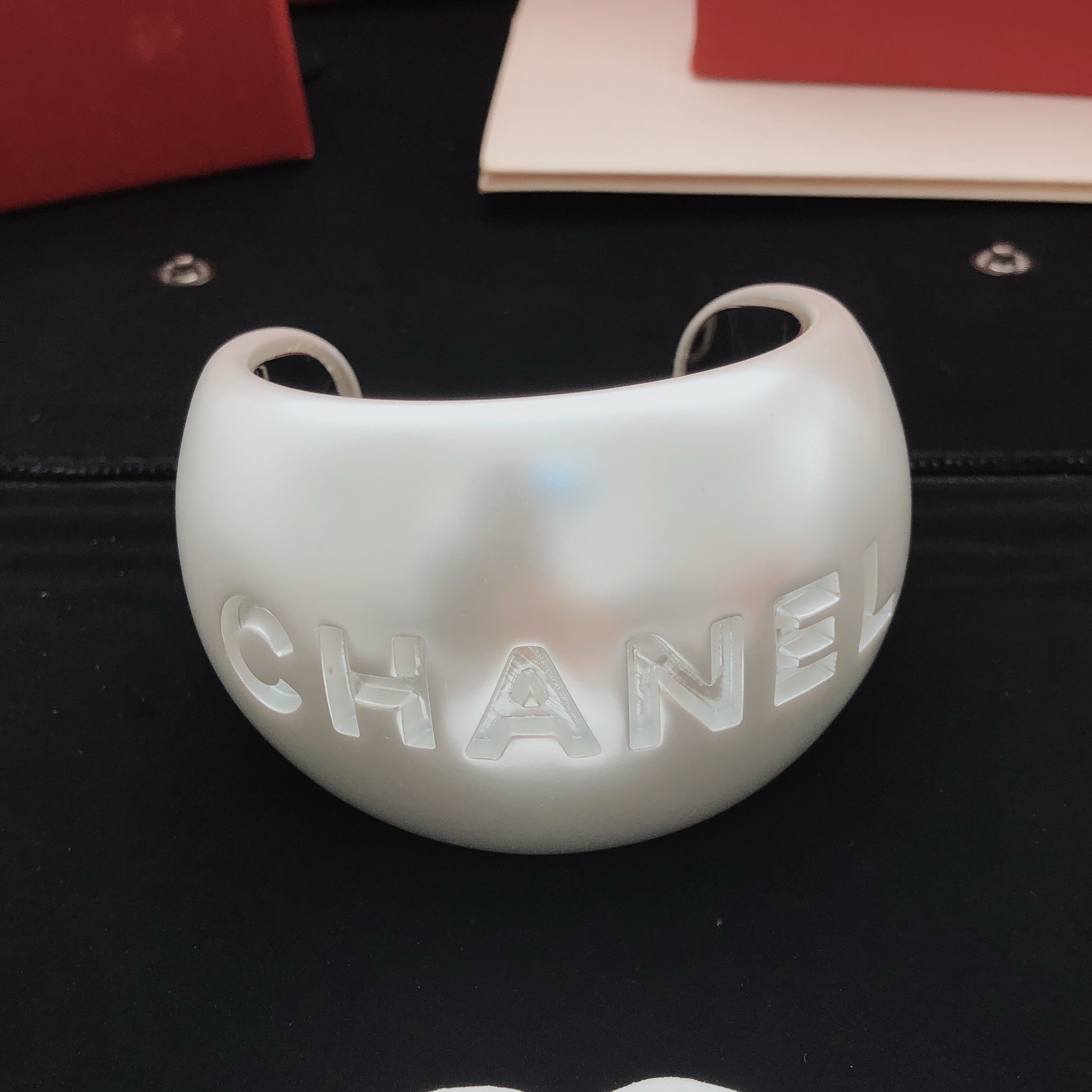 Chanel Embossed Logo Wide Cuff bracelet Pearlescent white resin with silver-tone metal inner lining One Size 6 5cm inner diameter
