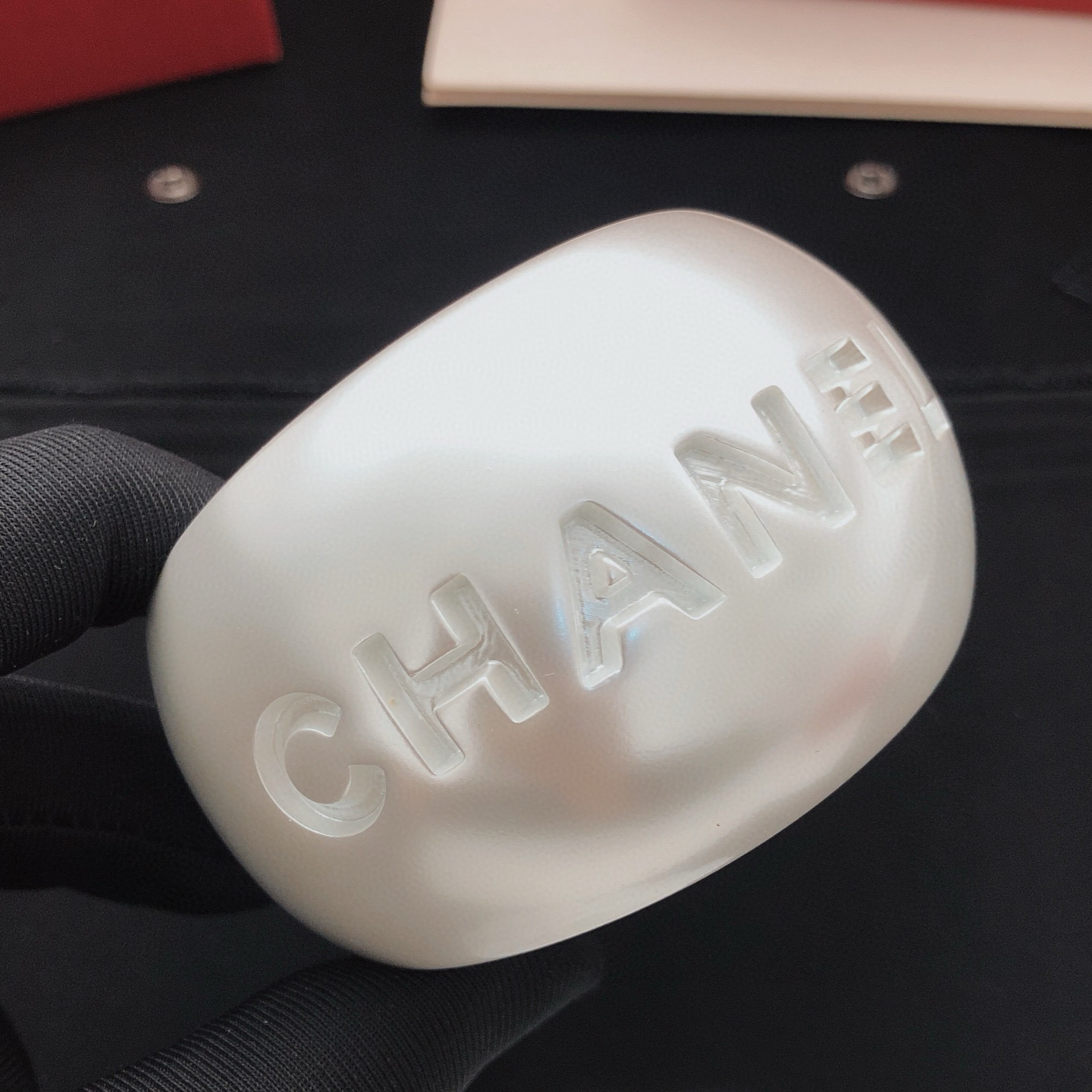 Chanel Embossed Logo Wide Cuff bracelet Pearlescent white resin with silver-tone metal inner lining One Size 6 5cm inner diameter