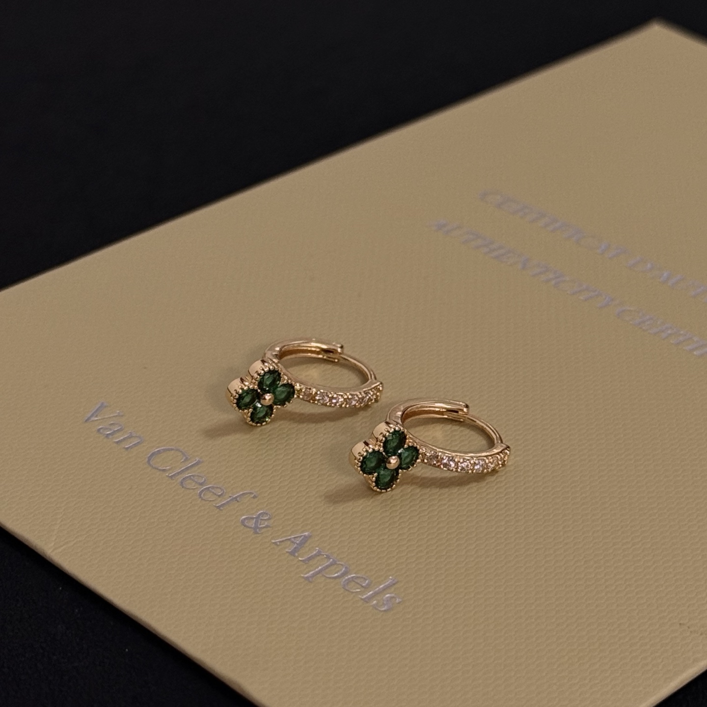Van Cleef Arpels Alhambra earrings yellow gold metal with green gemstone clover motifs and clear diamond accents 10mm hoop diameter