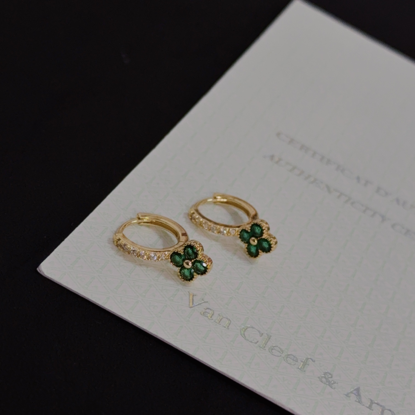 Van Cleef Arpels Alhambra earrings yellow gold metal with green gemstone clover motifs and clear diamond accents 10mm hoop diameter