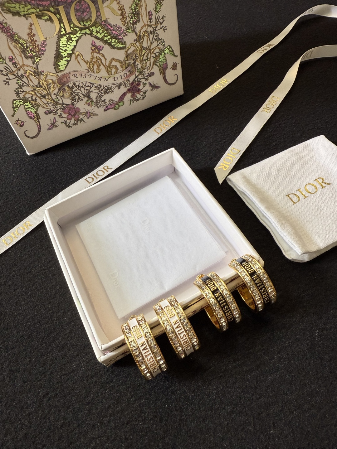 Dior Dior Code earrings gold-tone metal with clear crystal accents available with black or white enamel bands 1 5cm hoop diameter
