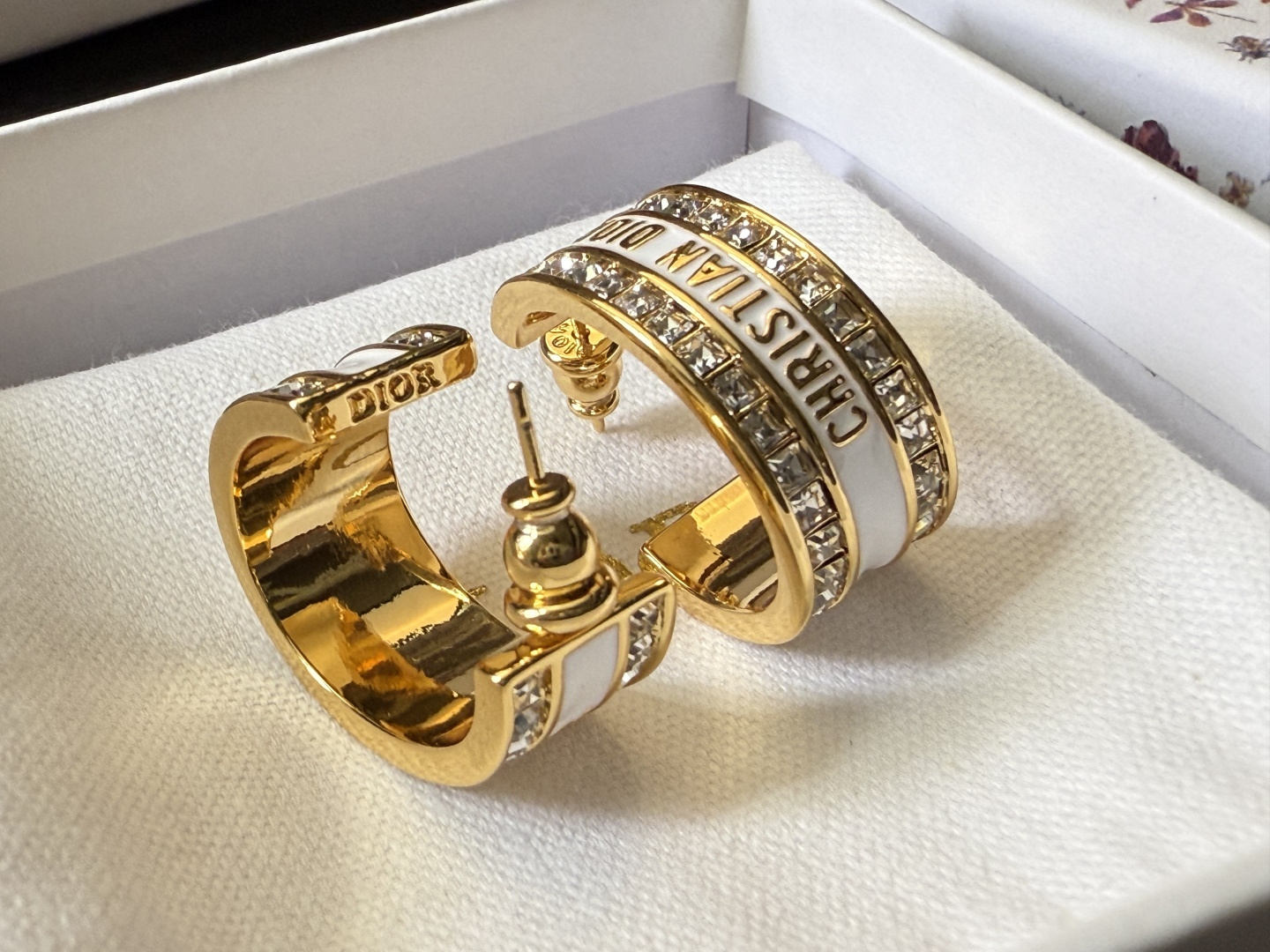 Dior Dior Code earrings gold-tone metal with clear crystal accents available with black or white enamel bands 1 5cm hoop diameter
