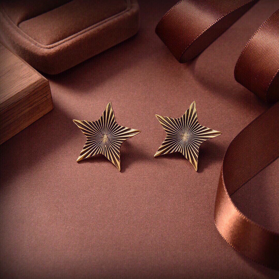 Saint Laurent 1961 Star Stud Earrings earrings Antique gold-tone metal with dark oxidized radial detailing no gemstones One Size approx 2 5cm width per earring