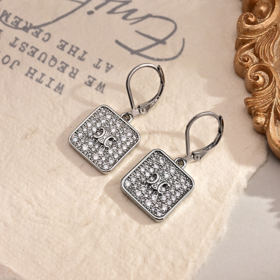 Celine Triomphe Nightfall earrings gold-tone metal with clear crystal accents 2 5cm drop length