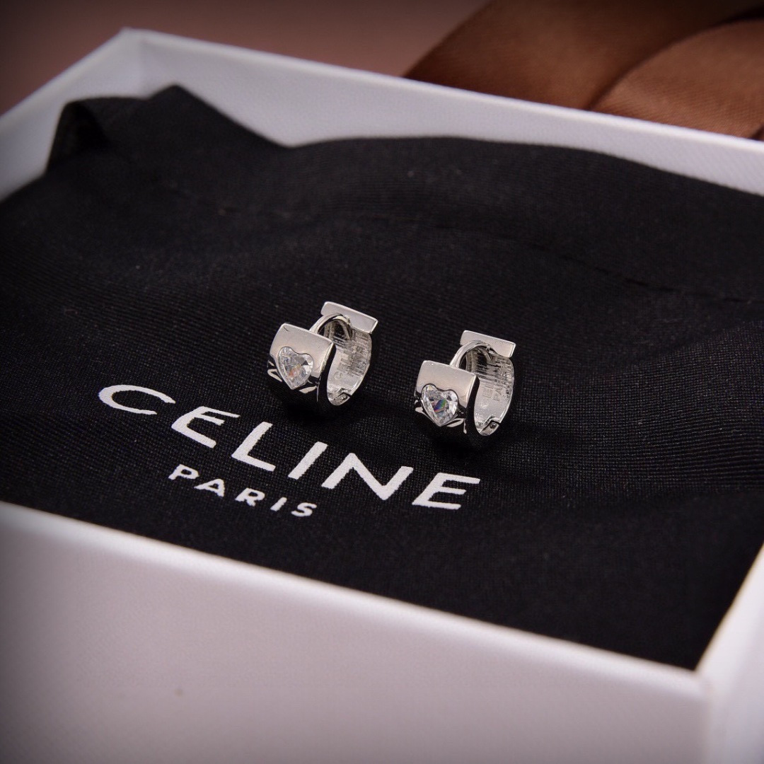 Celine Heart Crystal Huggie Hoop earrings silver-toned metal with clear heart-cut crystal accents 10mm outer diameter